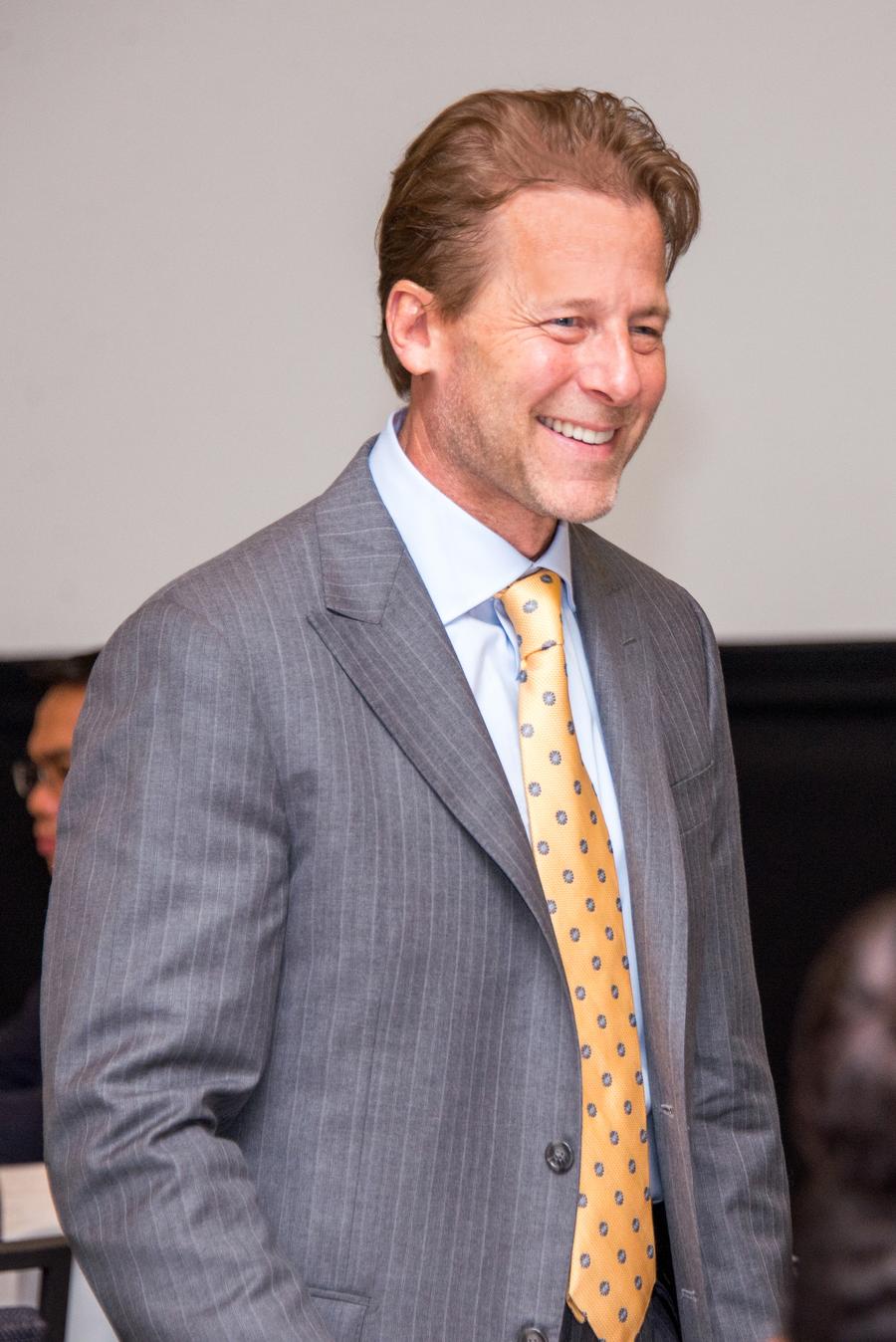 Rick Dahlgren presenting at a keynote with a projection screen behind him